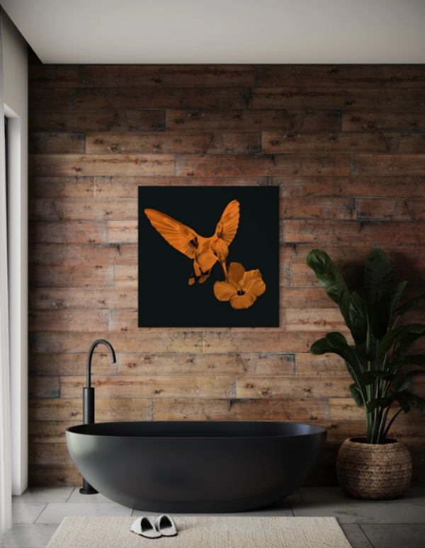 Modern bathroom with a copper hummingbird and hibiscus artwork on a wooden accent wall above a black bathtub.